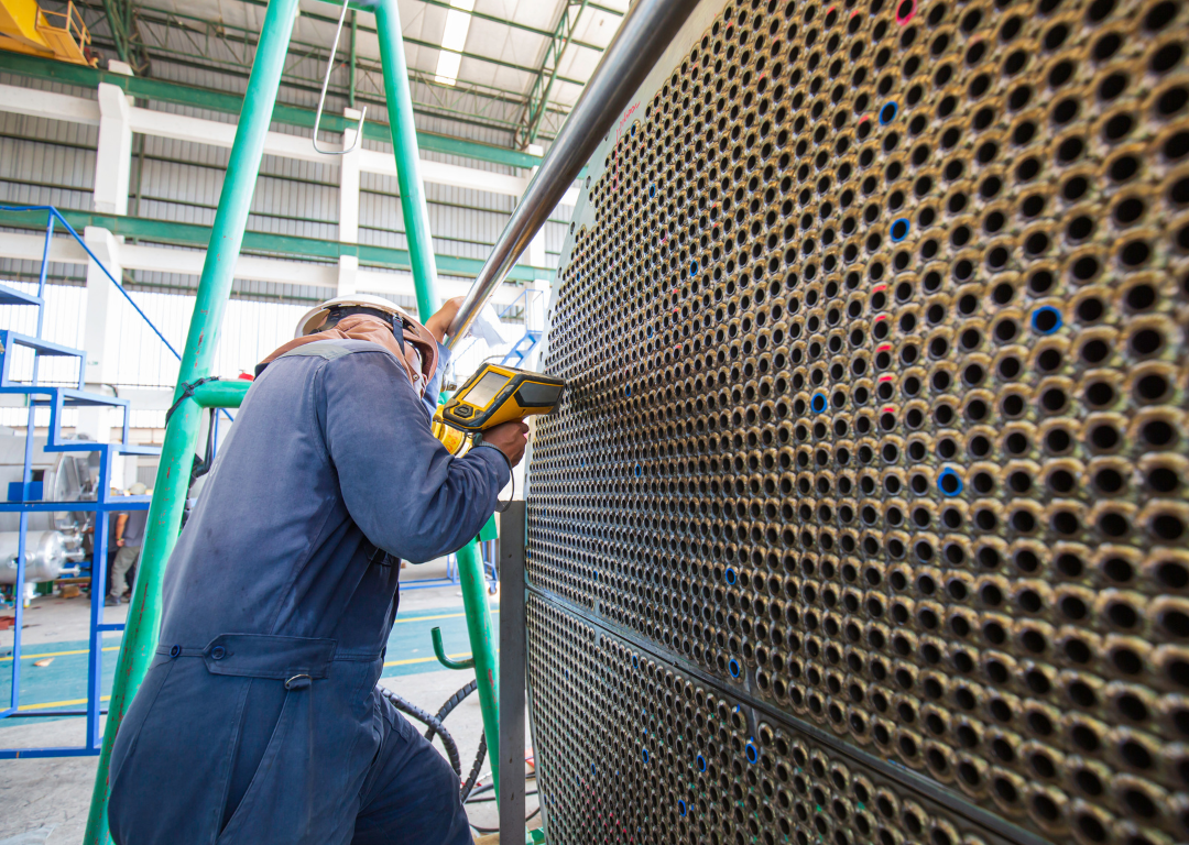 Shop technician inspecting a firetube bundle