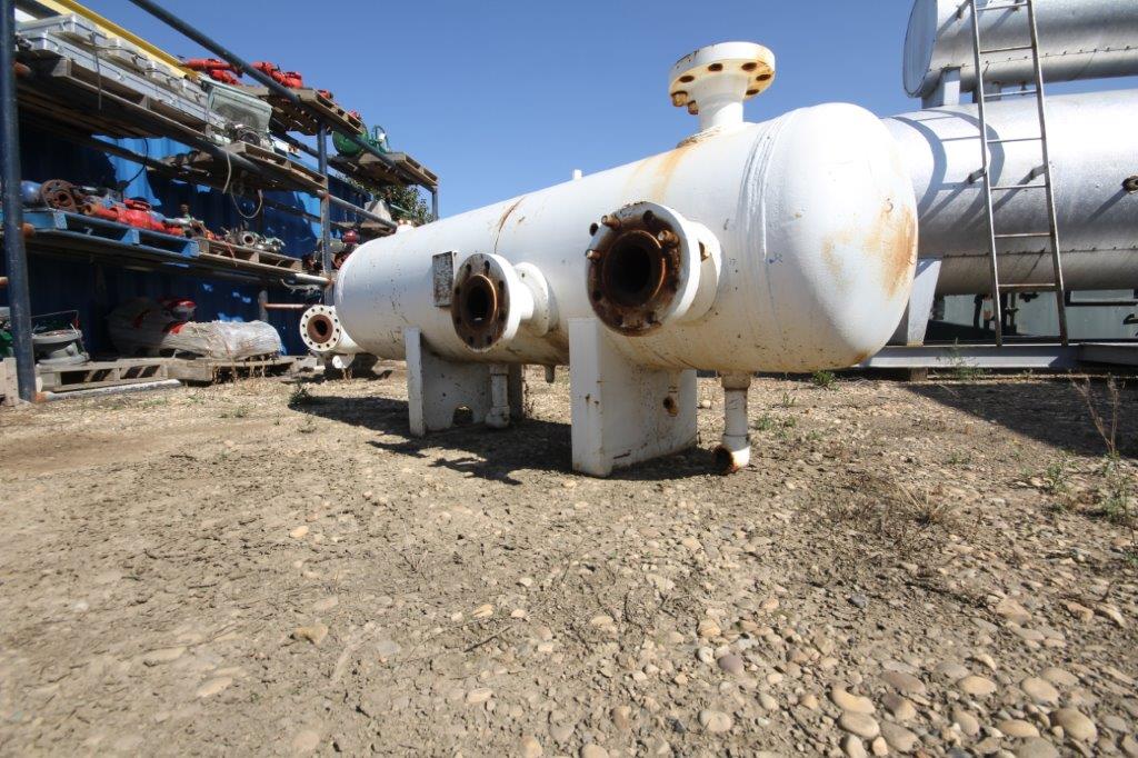 Horizontal white pressure vessel at job site